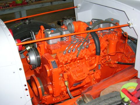 1989 Ford Bronco - Close-up of an orange engine with visible fuel lines and hoses.