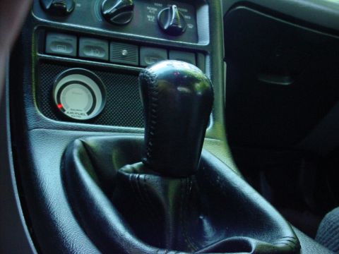 1994 Ford Probe - The interior of a 1994 Ford Probe is visible, the gear shifter and an air/fuel ratio gauge.