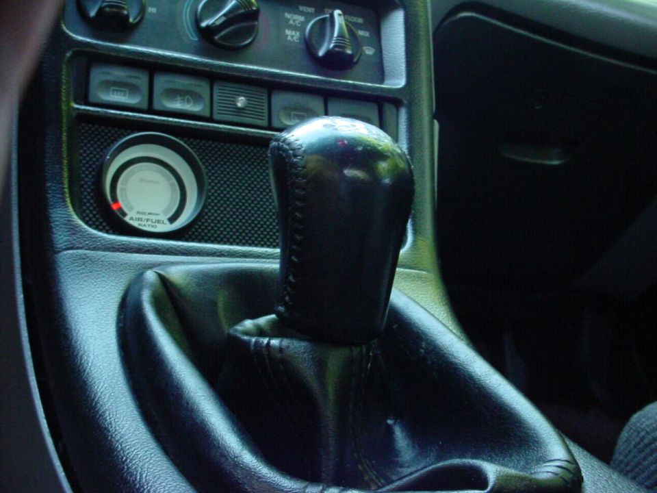 Interior of a 1994 Ford Probe showing the gear shifter and air/fuel gauge