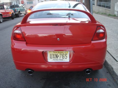 2005 Dodge SRT-4 - Rear view of a red Dodge Neon SRT-4 with a spoiler and dual exhaust pipes.
