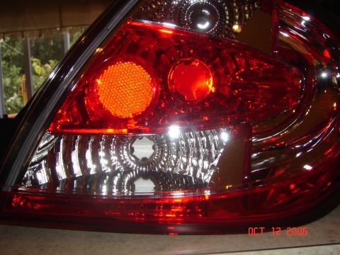 2005 Dodge SRT-4 - Tail light assembly with visible date stamp OCT 12 2006 and Supermotors.net logo.