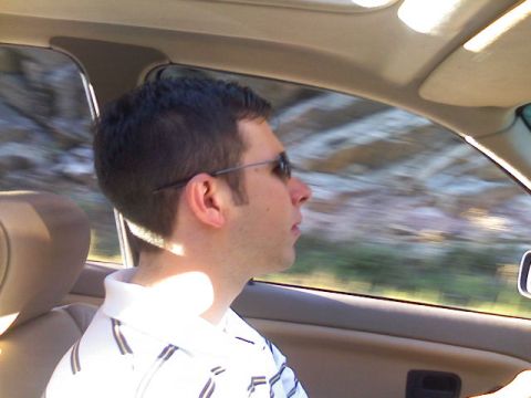 1996 Ford Probe - A man drives a car, with the landscape blurred by motion outside the window.
