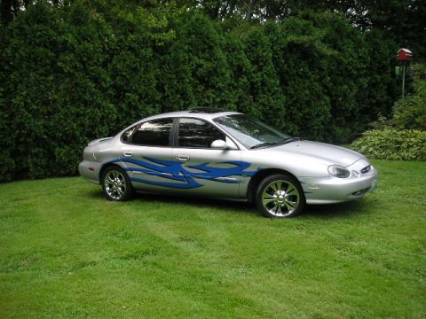 1999 Ford Taurus - This sedan has custom flame decals on its side and chrome wheels.