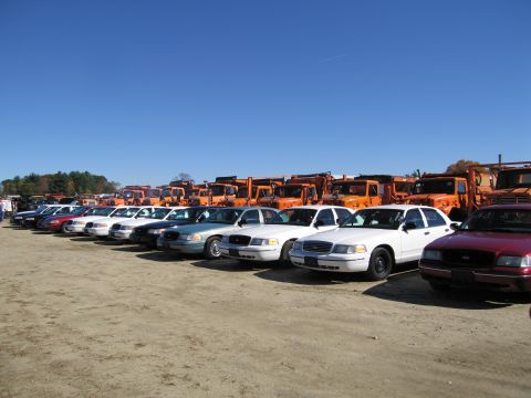 1991 Ford LTD Crown Victoria - A fleet of Crown Victoria Police Interceptors are lined up, with snow plows in the background.