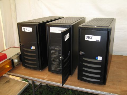 1991 Ford LTD Crown Victoria - Three black computer towers are lined up on a table, with one having its front panel open.