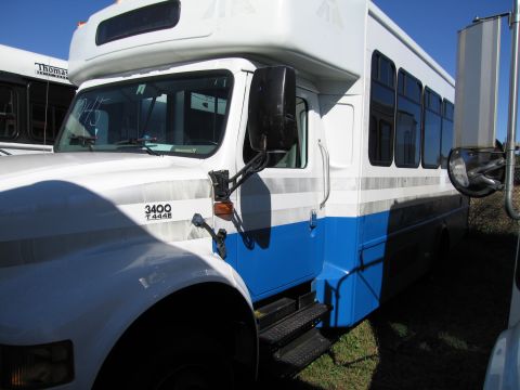 1991 Ford LTD Crown Victoria - A white and blue bus is seen from the front 3/4 angle. Text on the fender reads '3400 T444E'.