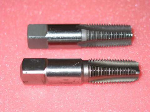 1981 Ford Bronco - Two metal taps are shown against a pink background. One tap is above the other.