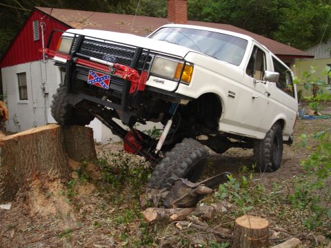 1989 Ford Bronco - This 1989 Ford Bronco is shown attempting to climb over a large tree stump during an off-road excursion.