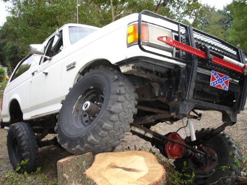 1989 Ford Bronco - This 1989 Ford Bronco is equipped with large off-road tires and a jack mounted on its grille guard.