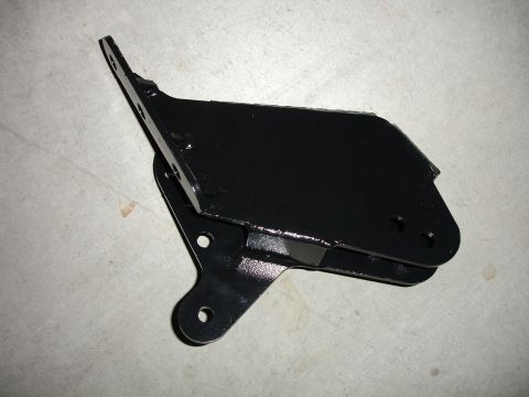 1996 Ford Bronco - A black metal bracket, likely a suspension component, is shown against a concrete background.