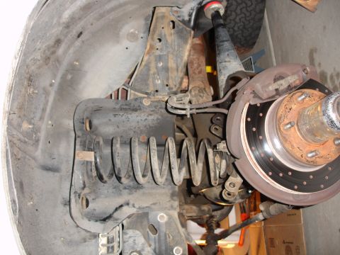 1996 Ford Bronco - This image shows the front suspension and brake components of a vehicle, likely during a repair or modification.