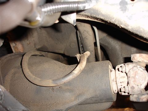 1996 Ford Bronco - Undercarriage view of a vehicle's rear axle and driveshaft, with visible hoses and suspension components.