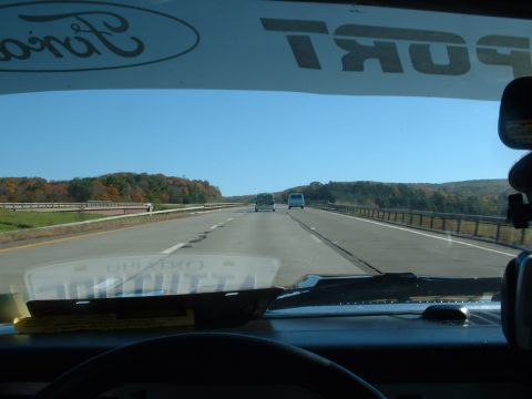 1978 Ford Mustang II - Driving on a highway with a clear blue sky and autumn foliage visible on the hillsides.