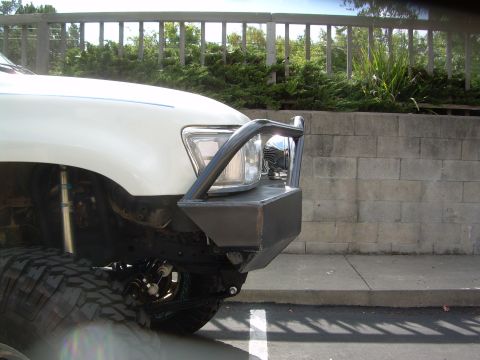 1993 Toyota 4Runner - Close-up of a custom front bumper with integrated lights on a white SUV.
