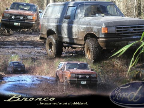 1988 Ford Bronco - Multiple Ford Broncos navigate a challenging muddy off-road course.