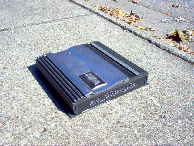 Car amplifier with 'VFL' logo on a concrete surface