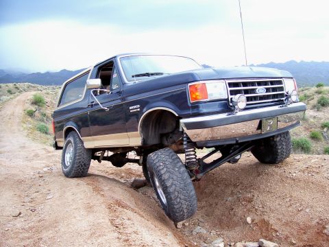1991 Ford Bronco - This 1991 Ford Bronco navigates a steep, rocky incline on a desert trail.