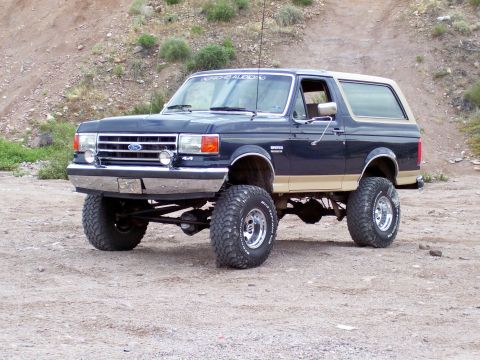 1991 Ford Bronco - This lifted Ford Bronco features a two-tone paint scheme and aggressive off-road tires.