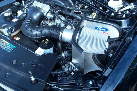 2006 Ford Mustang - Close-up of a Ford Racing cold air intake installed in the engine bay of a Mustang, indicating a model year around 2005-2010.