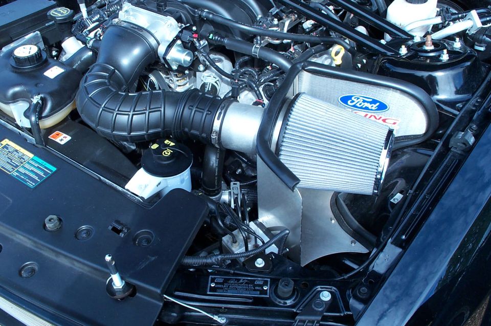 Ford Racing air intake system on a dark-colored engine bay, likely a 2005-2010 Mustang