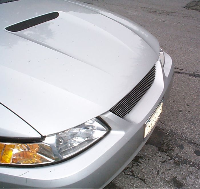 Silver 2000 Ford Mustang front end, showing custom grille and hood scoop