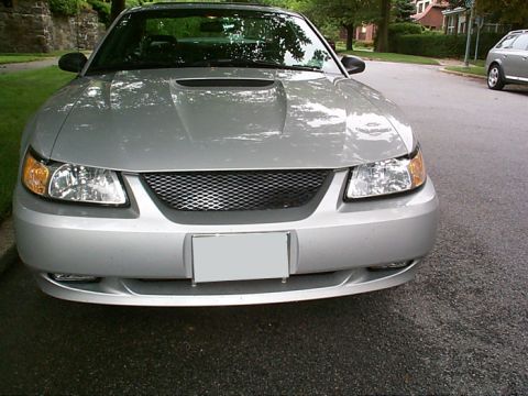 2000 Ford Mustang - Front view of a silver 2000 Ford Mustang, a custom grille and hood scoop.