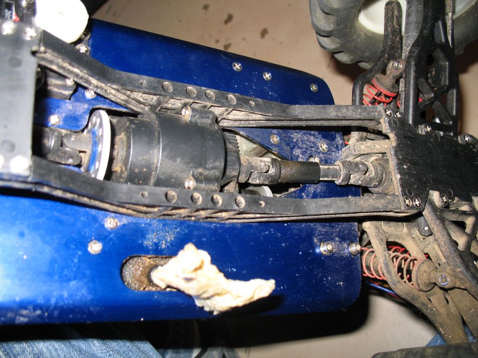 Close-up of a blue RC car chassis with driveshaft and clutch