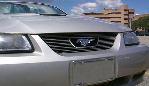 2000 Ford Mustang - The grille and emblem on this silver Ford Mustang appear to be from the 2000 model year.