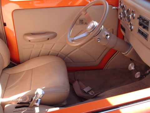 1995 Ford Probe - The custom interior features tan upholstery, a unique door panel design, and a classic steering wheel.