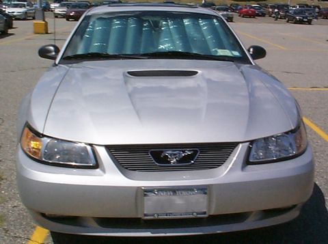 2000 Ford Mustang - This silver 2000 Ford Mustang features a custom grille and a sunshade visible through the windshield.
