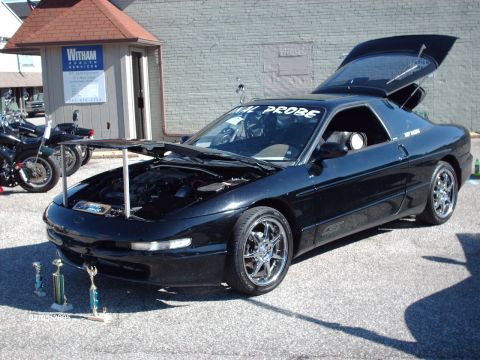 1995 Ford Probe - Black 1995 Ford Probe displayed at a car show with its hood and trunk open.