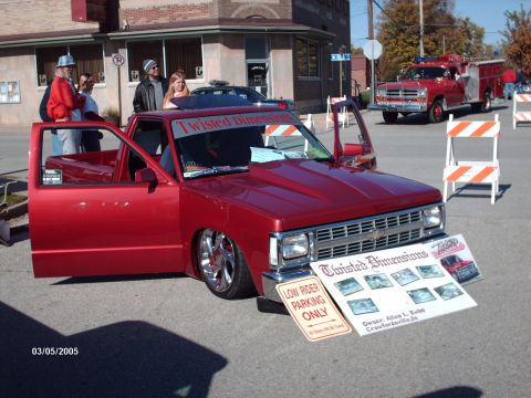 1995 Ford Probe - A custom red pickup truck is displayed at an outdoor event, with a fire truck visible in the background.