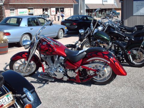 1995 Ford Probe - Custom motorcycle with flame paint job at a car and bike show.