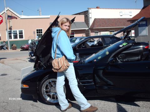 1995 Ford Probe - A black convertible sports car is displayed with its hood open at an outdoor car show.