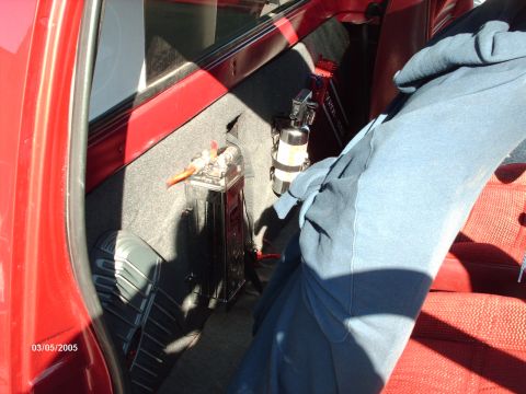 1995 Ford Probe - Custom audio setup and fire extinguisher visible in the interior of a red vehicle.
