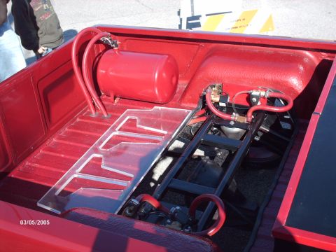 1995 Ford Probe - Custom air tank and plumbing installed in the bed of a red pickup truck.