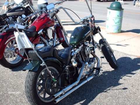 1995 Ford Probe - Custom motorcycles on display at a car and bike show.