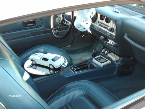 1995 Ford Probe - Interior of a classic car, a model car and fuzzy dice, dated 03/05/2005.