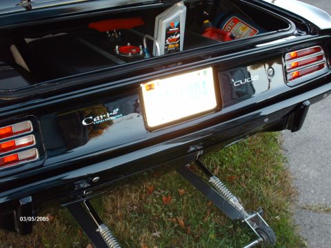 1995 Ford Probe - A black 1970 Plymouth Barracuda is shown with a custom trunk setup, including a fuel cell and oil, and the distinctive 'cuda badging.