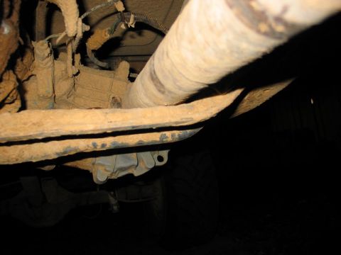 1989 Ford F-150 - Close-up view of the underbody of a truck, showing the exhaust system and suspension parts.
