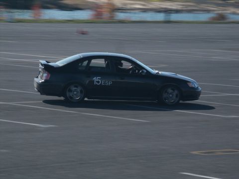 2001 Mercury Grand Marquis - Black sedan with racing numbers on the door is seen on a track during an event.