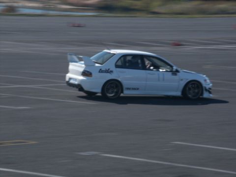2001 Mercury Grand Marquis - A white Mitsubishi Lancer Evolution is seen on a race track, with "Tire Rack" visible on its side.