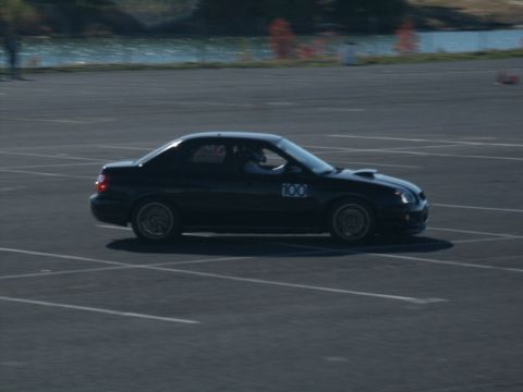 2001 Mercury Grand Marquis - A black sedan with a racing number is on a track, possibly during an event.