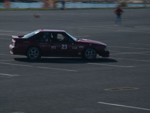 2001 Mercury Grand Marquis - A red coupe with racing decals is seen on a track, possibly during an event.