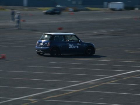 2001 Mercury Grand Marquis - A blue Mini Cooper is seen on a race track during an event.