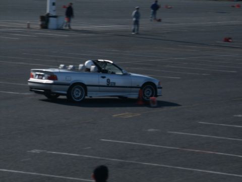 2001 Mercury Grand Marquis - A silver convertible sports car is seen on a paved track during an event.
