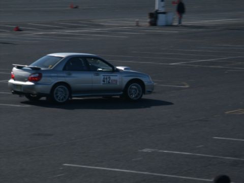 2001 Mercury Grand Marquis - A silver sedan with racing decals is seen on a paved surface, marked lot.