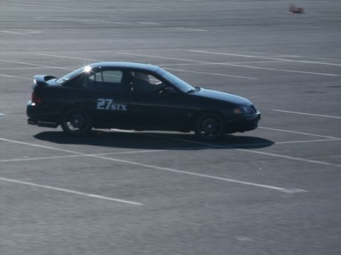 2001 Mercury Grand Marquis - A black sedan with racing numbers "27 STX" is parked on a paved lot.