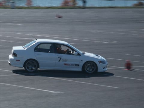 2001 Mercury Grand Marquis - A white sedan with racing decals navigates a track with orange cones.