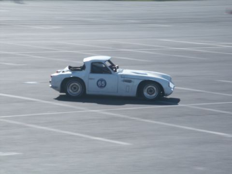 2001 Mercury Grand Marquis - A white sports car with racing number 65 is seen on a track.